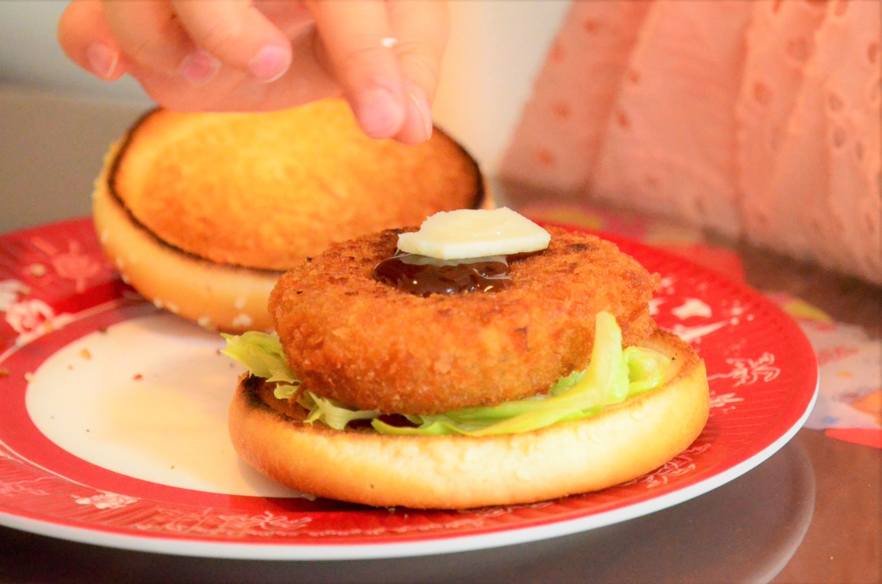 The croquette burger is topped with cheese
