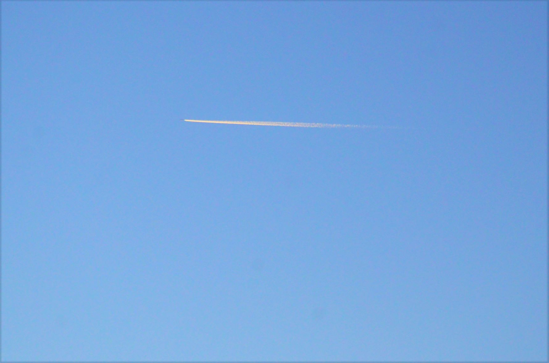 Contrails shining in the blue sky